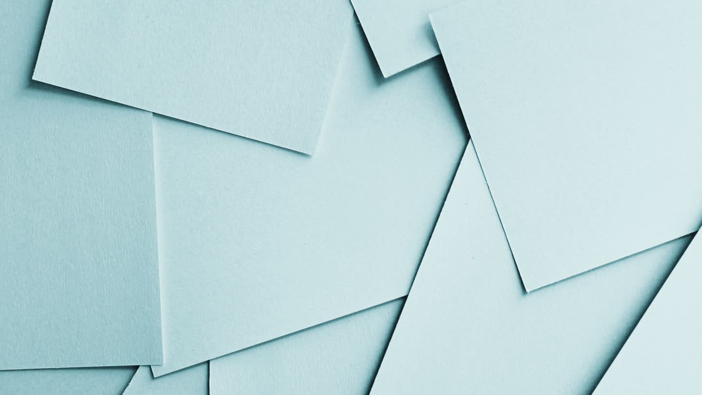 Loose sheets of paper overlapping on a surface